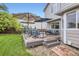 Inviting backyard featuring a spacious deck area, stylish patio furniture, and a well-manicured lawn at 1641 Cedarwood Dr, Longmont, CO 80504