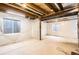 Large unfinished basement with insulation and windows, offering potential for future living space at 1641 Cedarwood Dr, Longmont, CO 80504