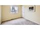 Empty bedroom with neutral carpeting, a window, and fresh paint ready for personalization at 1641 Cedarwood Dr, Longmont, CO 80504