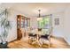 Bright dining room with a wooden table, hutch, and large window at 1641 Cedarwood Dr, Longmont, CO 80504