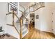 Grand entryway with a staircase, hardwood floors, and a glimpse into the living room with a fireplace at 1641 Cedarwood Dr, Longmont, CO 80504