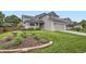 Charming two-story home with a well-manicured lawn and attractive landscaping at 1641 Cedarwood Dr, Longmont, CO 80504