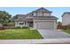 Traditional two-story home boasts a two-car garage and manicured front lawn at 1641 Cedarwood Dr, Longmont, CO 80504