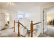 Upstairs landing featuring neutral carpeting, white banisters, and views into multiple rooms at 1641 Cedarwood Dr, Longmont, CO 80504