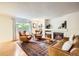 Warm living room with a fireplace, leather furniture, and an ornate area rug at 1641 Cedarwood Dr, Longmont, CO 80504
