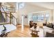Bright living area with a staircase, large windows, and wood floors at 1641 Cedarwood Dr, Longmont, CO 80504