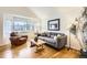 Cozy living room featuring a large window, hardwood floors, and modern decor at 1641 Cedarwood Dr, Longmont, CO 80504