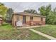 Brick home with a cozy backyard featuring a small patio, a grill, and lush ground cover, perfect for outdoor living at 1635 Winona Ct, Denver, CO 80204