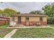 Charming brick house backyard with a small patio, outdoor seating, grill, and beautiful ground cover, ideal for relaxing at 1635 Winona Ct, Denver, CO 80204