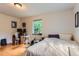 Bedroom features hardwood floors, a work space, and natural light at 1635 Winona Ct, Denver, CO 80204
