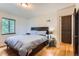 Bedroom boasts hardwood floors, natural light, and neutral walls at 1635 Winona Ct, Denver, CO 80204