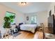 Bedroom features hardwood floors, a cat tower, and natural light at 1635 Winona Ct, Denver, CO 80204