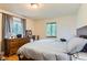 Bedroom features hardwood floors, natural light, and gray curtains at 1635 Winona Ct, Denver, CO 80204