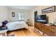 Bedroom features hardwood floors, a TV, and natural light at 1635 Winona Ct, Denver, CO 80204