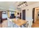 Elegant dining area with hardwood floors, stylish seating, and an open view to the living room at 1635 Winona Ct, Denver, CO 80204