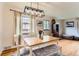 Bright dining room featuring a modern light fixture, hardwood floors, and ample natural light at 1635 Winona Ct, Denver, CO 80204