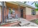 Inviting front porch with seating, showcasing the brick exterior and a welcoming entrance at 1635 Winona Ct, Denver, CO 80204