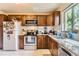 Traditional kitchen features wood cabinets, stainless steel appliances, and granite countertops at 1635 Winona Ct, Denver, CO 80204