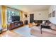 Comfortable living room featuring hardwood floors, large windows, and a welcoming atmosphere at 1635 Winona Ct, Denver, CO 80204