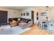 Open-concept living area with hardwood floors, stylish furnishings, and a seamless flow at 1635 Winona Ct, Denver, CO 80204