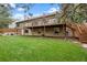Lush backyard with a spacious deck, patio area, and well-maintained lawn at 7881 S Ivy Ct, Centennial, CO 80112