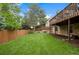 Large backyard with well-maintained lawn, fence, and patio area, perfect for outdoor activities at 7881 S Ivy Ct, Centennial, CO 80112