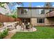 Serene backyard featuring a patio, lush lawn, and stone landscaping at 7881 S Ivy Ct, Centennial, CO 80112