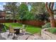 Large backyard featuring a patio, manicured lawn, and privacy landscaping at 7881 S Ivy Ct, Centennial, CO 80112
