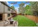 Expansive backyard featuring well-maintained lawn, trees, patio, and a deck at 7881 S Ivy Ct, Centennial, CO 80112