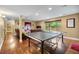 Finished basement with a ping pong table, recessed lights, and hardwood floors at 7881 S Ivy Ct, Centennial, CO 80112