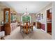 Formal dining room showcases a large china cabinet and elegant lighting fixture at 7881 S Ivy Ct, Centennial, CO 80112