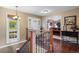 Inviting foyer with hardwood floors, staircase, and front door with decorative glass at 7881 S Ivy Ct, Centennial, CO 80112