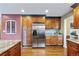 Kitchen with stainless steel refrigerator and abundant wood cabinets at 7881 S Ivy Ct, Centennial, CO 80112