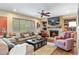 Comfortable living room featuring a fireplace, built-in shelves, and plush seating at 7881 S Ivy Ct, Centennial, CO 80112