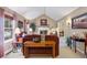 Inviting living room featuring vaulted ceilings, fireplace and neutral color palette at 7881 S Ivy Ct, Centennial, CO 80112