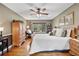 Relaxing main bedroom with wood floors, a ceiling fan, and a sitting area at 7881 S Ivy Ct, Centennial, CO 80112
