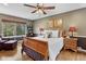 Cozy main bedroom with wood floors, a ceiling fan, and natural light at 7881 S Ivy Ct, Centennial, CO 80112