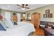 Spacious main bedroom featuring a ceiling fan, hardwood floors and a walk-in closet at 7881 S Ivy Ct, Centennial, CO 80112