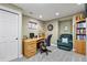 Functional home office with a desk, chair, bookcase, and neutral carpet at 7881 S Ivy Ct, Centennial, CO 80112