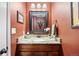 Elegant powder room with granite countertop and decorative mirror at 7881 S Ivy Ct, Centennial, CO 80112