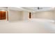 Spacious basement featuring neutral colors and plenty of room for activities and storage at 8523 S Flower Ct, Littleton, CO 80128