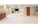 Large finished basement with wet bar, fireplace, and TV at 8523 S Flower Ct, Littleton, CO 80128
