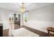 Elegant dining room with hardwood floors, wainscoting, and a stylish chandelier at 8523 S Flower Ct, Littleton, CO 80128