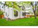 Light gray two-story home with well-maintained lawn and covered patio, central AC unit at 8523 S Flower Ct, Littleton, CO 80128