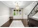 Bright living room features hardwood floors, a decorative fireplace, and an ornate staircase at 8523 S Flower Ct, Littleton, CO 80128