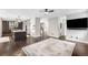 Spacious living area features an open layout with hardwood floors and a view of the staircase at 8523 S Flower Ct, Littleton, CO 80128