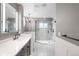 Elegant main bathroom with single vanity, designer tile, and glass shower with rainfall shower head at 8523 S Flower Ct, Littleton, CO 80128