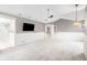 Bright main bedroom featuring neutral colors, high ceilings, and adjoining bathroom with stylish tile in shower at 8523 S Flower Ct, Littleton, CO 80128
