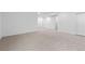 Spacious carpeted basement with white walls and trim, featuring multiple doorways and potential for various uses at 5625 W 141St Ln, Broomfield, CO 80020