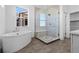 Bathroom with modern soaking tub and glass-enclosed shower provides luxury at 5625 W 141St Ln, Broomfield, CO 80020